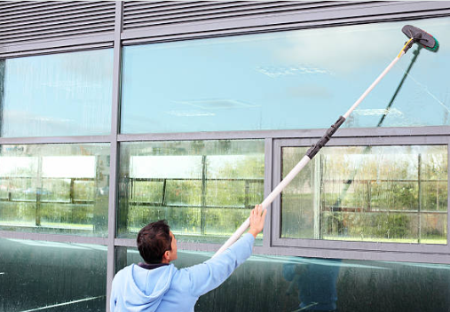 close up of water fed pole window cleaning on commercial building
