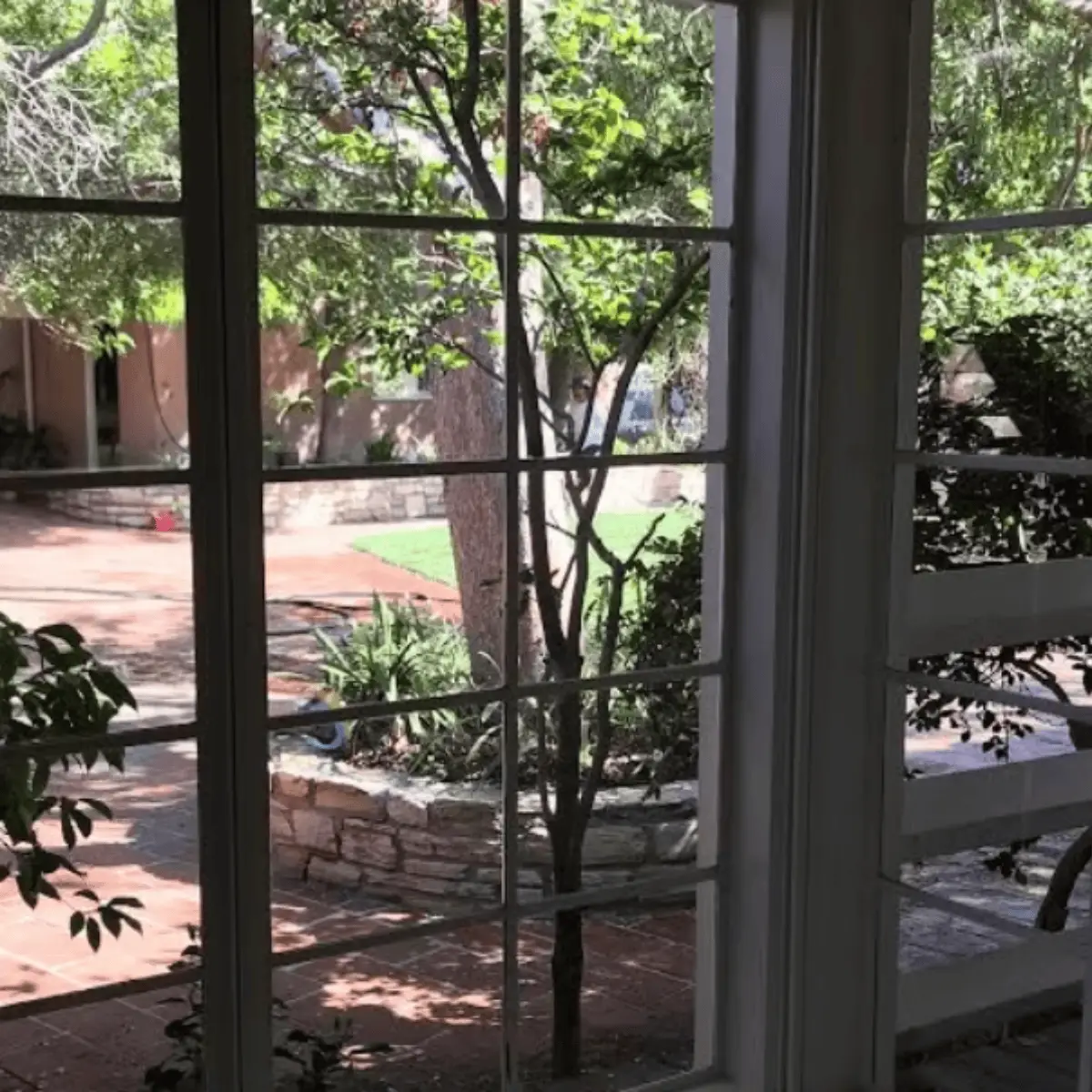 Ocean Breeze Window Cleaning sparkling clean windows overlooking landscaped bak garden