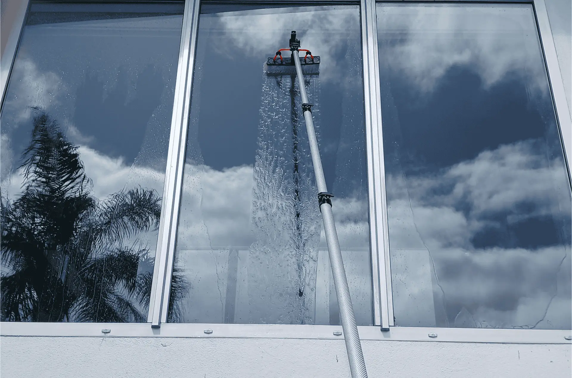 Water fed pole cleaning a picture window