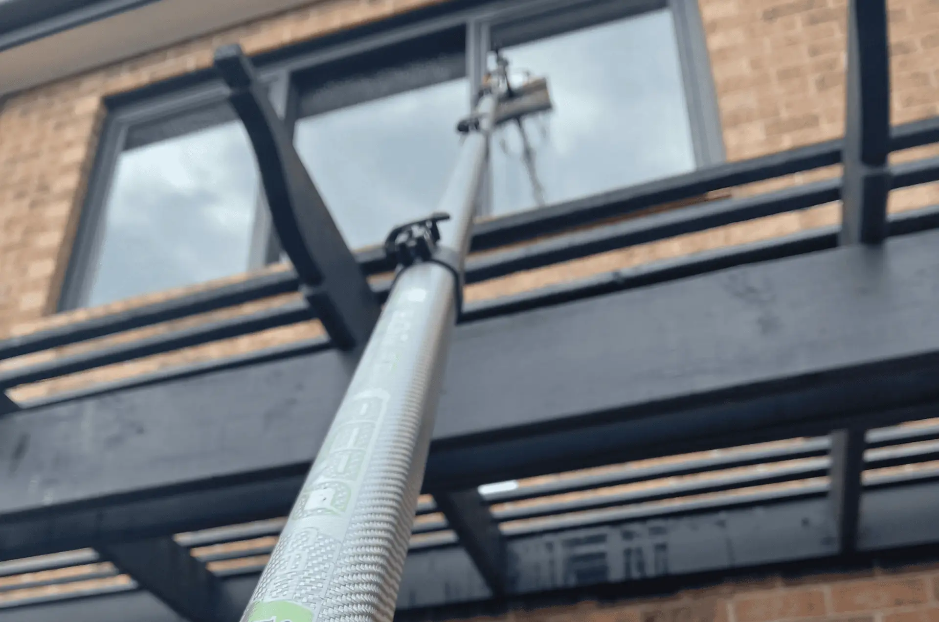 Water fed pole cleaning windows over a frame